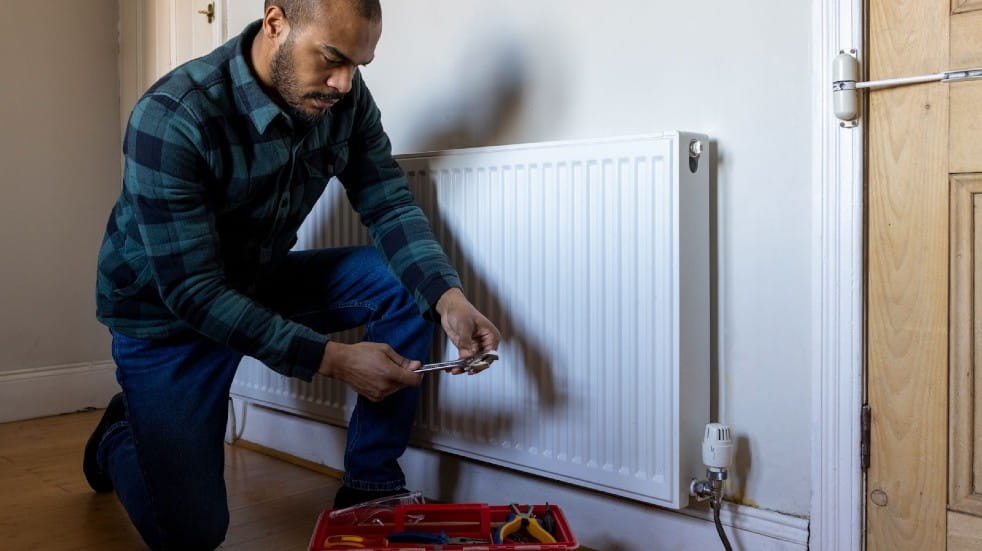 Man fixing radiator